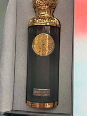 Decorative bottle with gold accents on a gray surface
